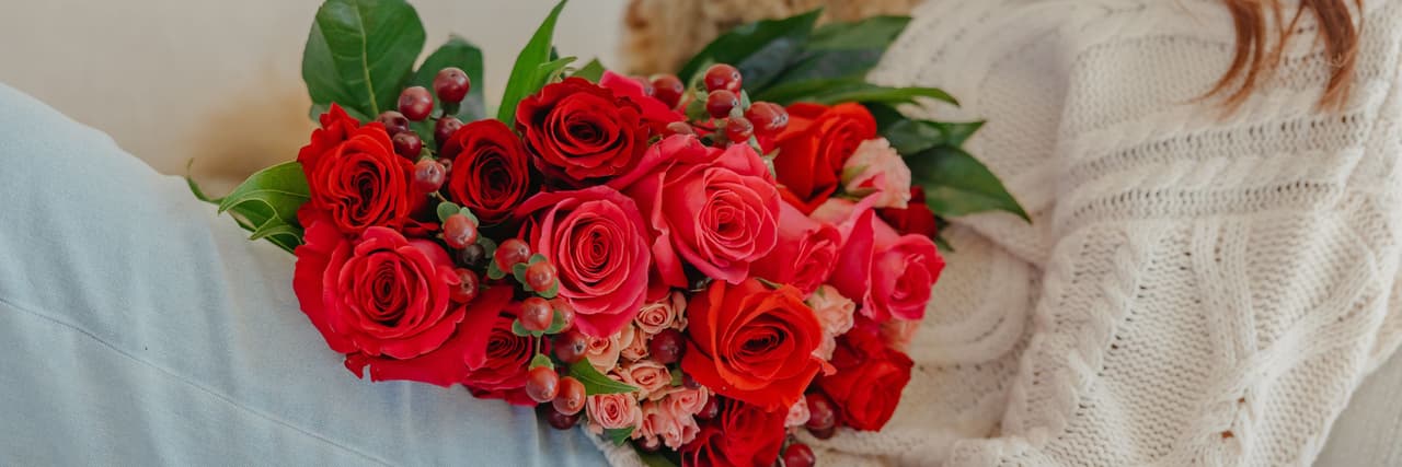 Vibrant red and pink roses beautifully arranged, creating a stunning floral display.