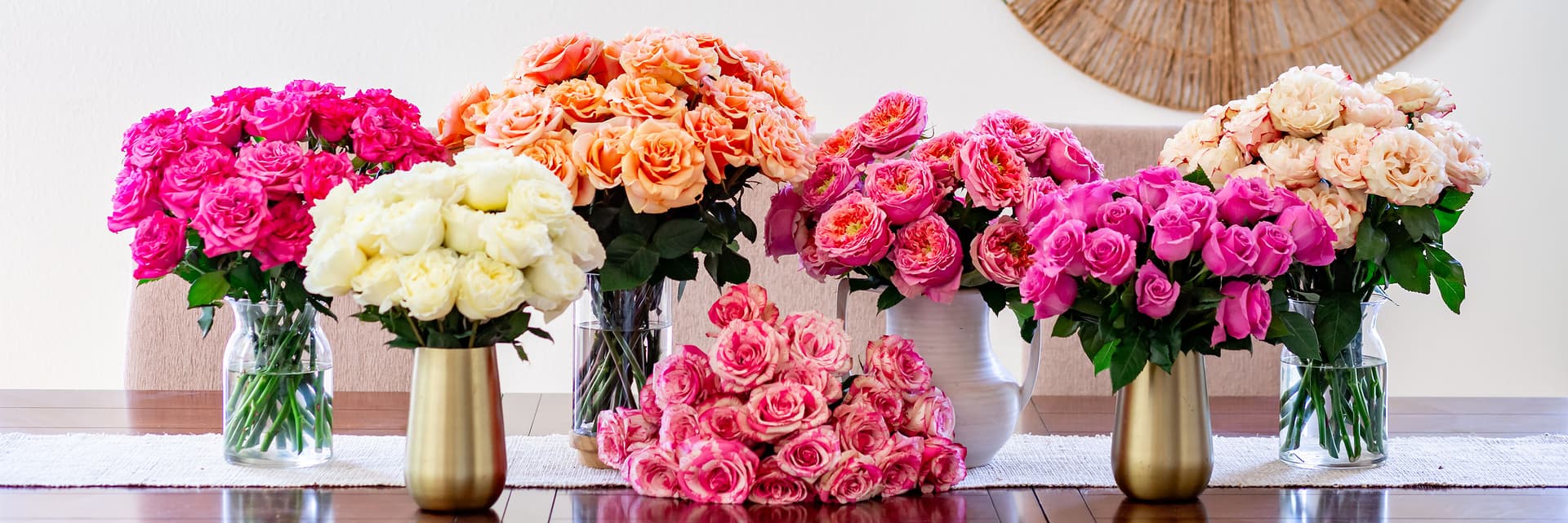 Vibrant collection of rose bouquets in various colors displayed elegantly on a table.